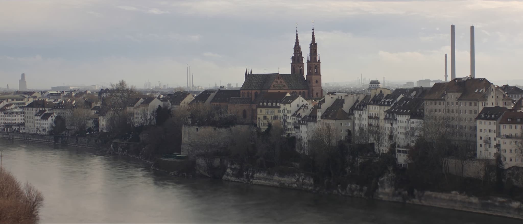 The bend of the Rhine, the minster towers above the old town, chimneys downstream