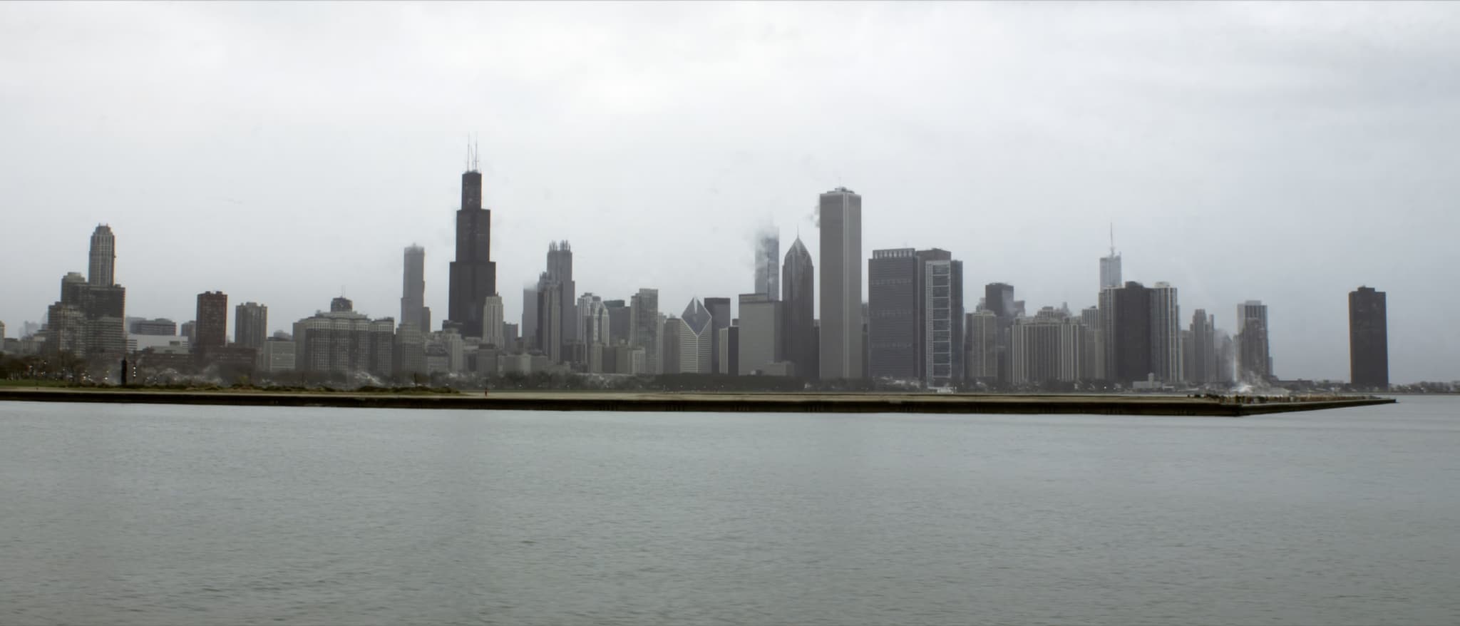 The wall of towers along the lakefront, flat water in front of it